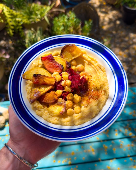 Homemade hummus topped with roasted potato, chickpeas and paprika.