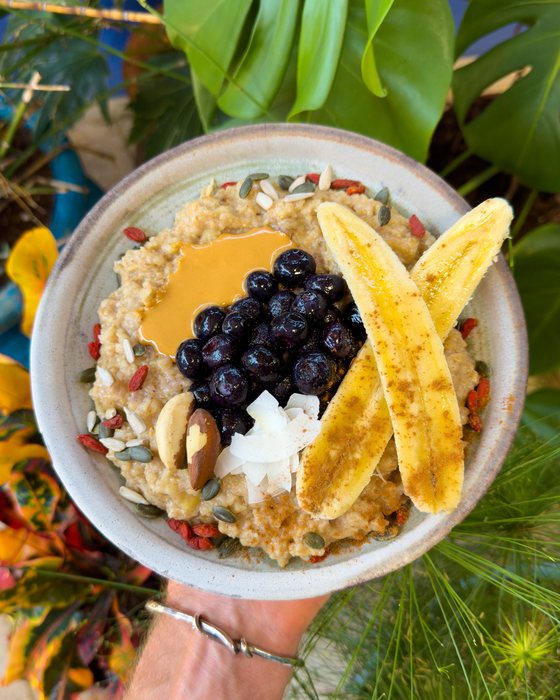 Apple cinnamon ginger oats topped with banana, blueberries and seeds.
